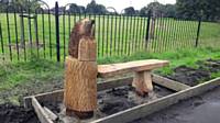 Installation of the hedgehog bench 2017. The wood carved bench was created from one of the Cherry Trees felled in the park